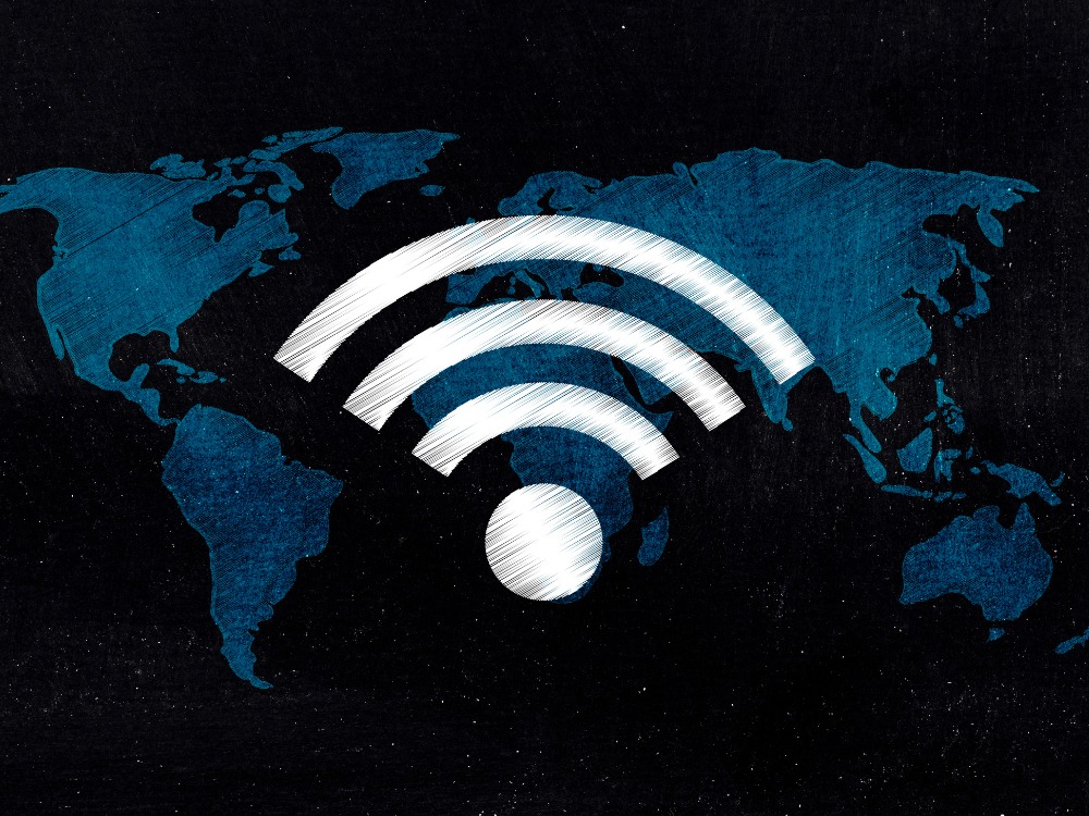 Símbolo de conexão sem fio sobre um mapa-múndi ilustra a expansão da internet e das redes de fibra óptica no mundo.